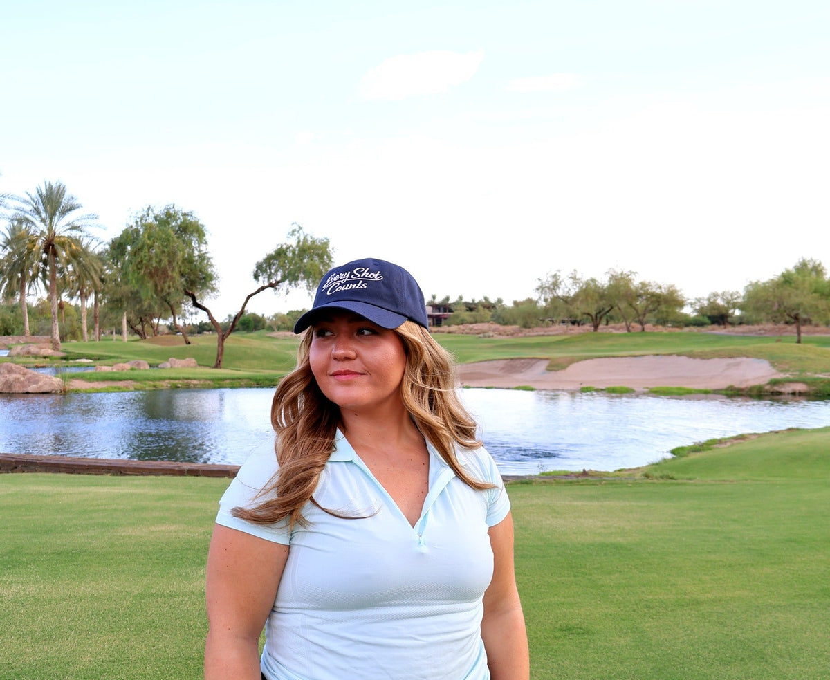 Golfer wearing the navy Every Shot Counts hat on the course at Vistancia