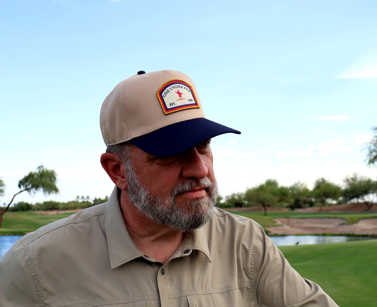 Golfer wearing the One Under Vintage two-tone patch hat at Vistancia Golf Club
