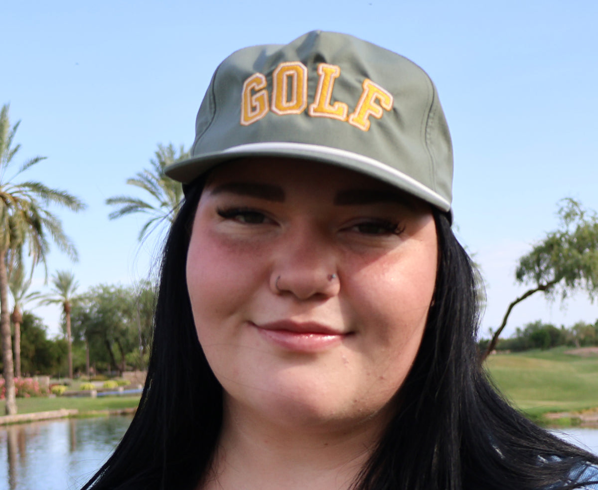 Golfer wearing the moss Golf Script performance rope hat on the course