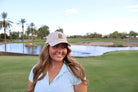 Woman wearing the stone Golf Cactus embroidered dad hat at Vistancia Golf Club