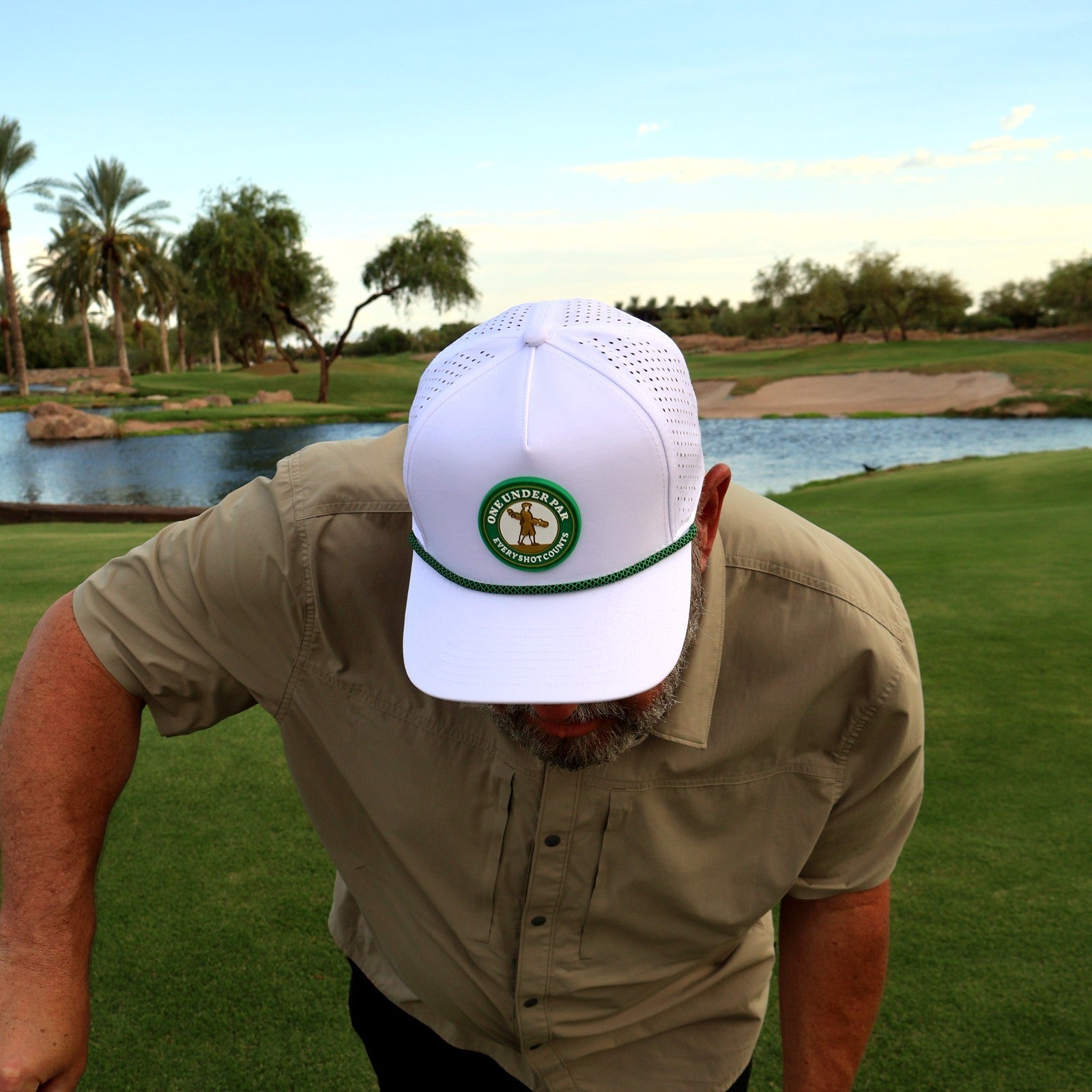 Golfer wearing the green and white One Under Classic rope hat at Vistancia