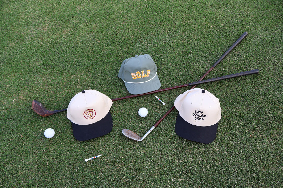 One Under Par golf hats styled with vintage clubs on the fairway