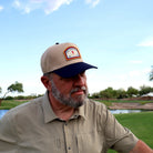 Golfer wearing the One Under Vintage two-tone patch hat at Vistancia Golf Club