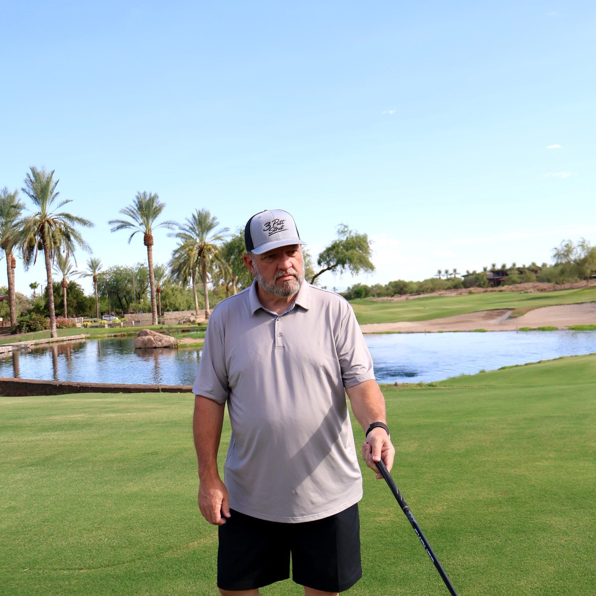 Golfer wearing the Three Putt Strut two-tone hat on the course