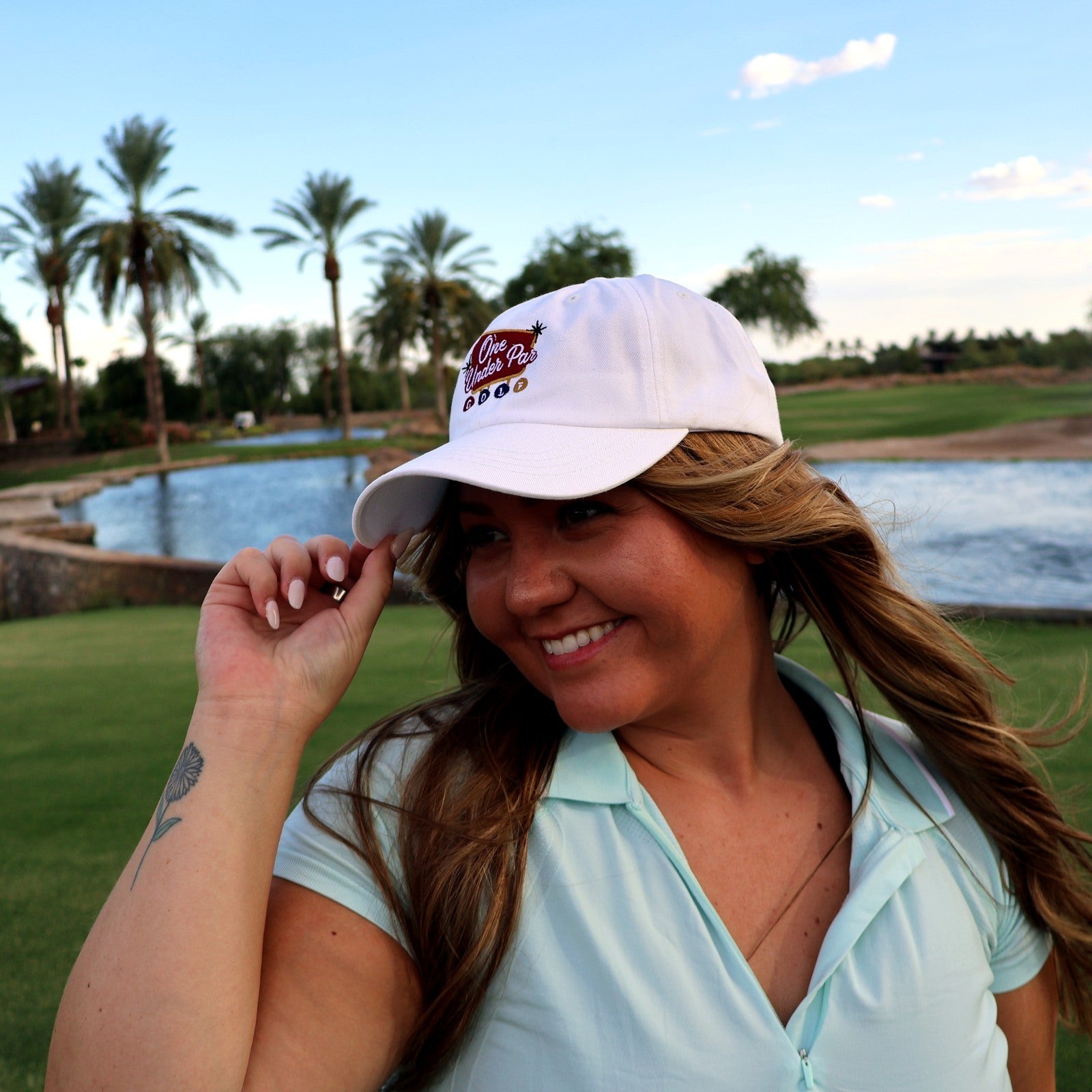 Woman wearing the white Vegas Style embroidered golf hat at Vistancia Golf Club