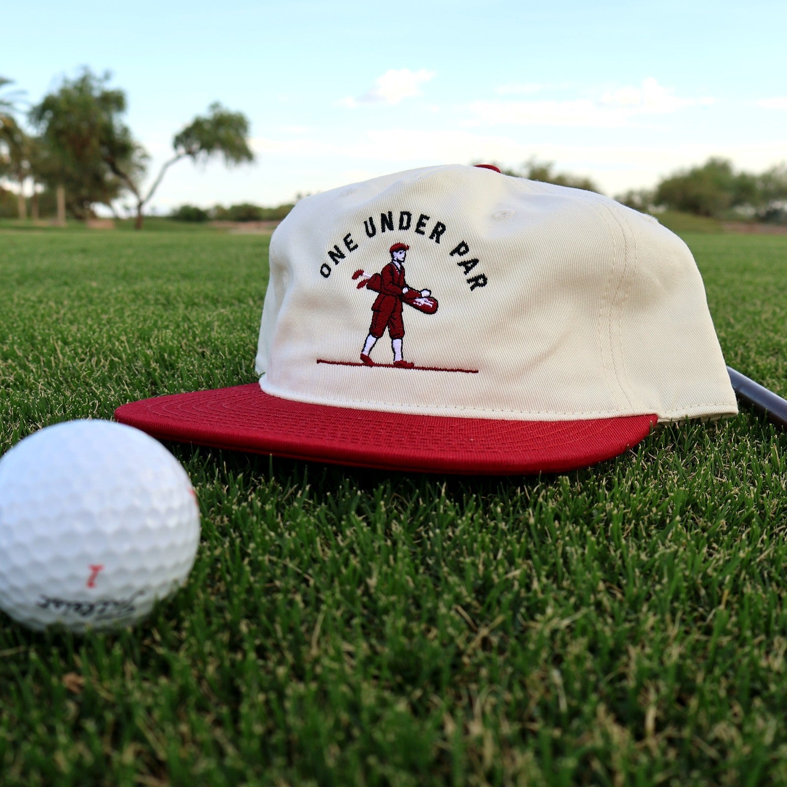Vintage Golfer natural and cardinal hat photographed on the golf course