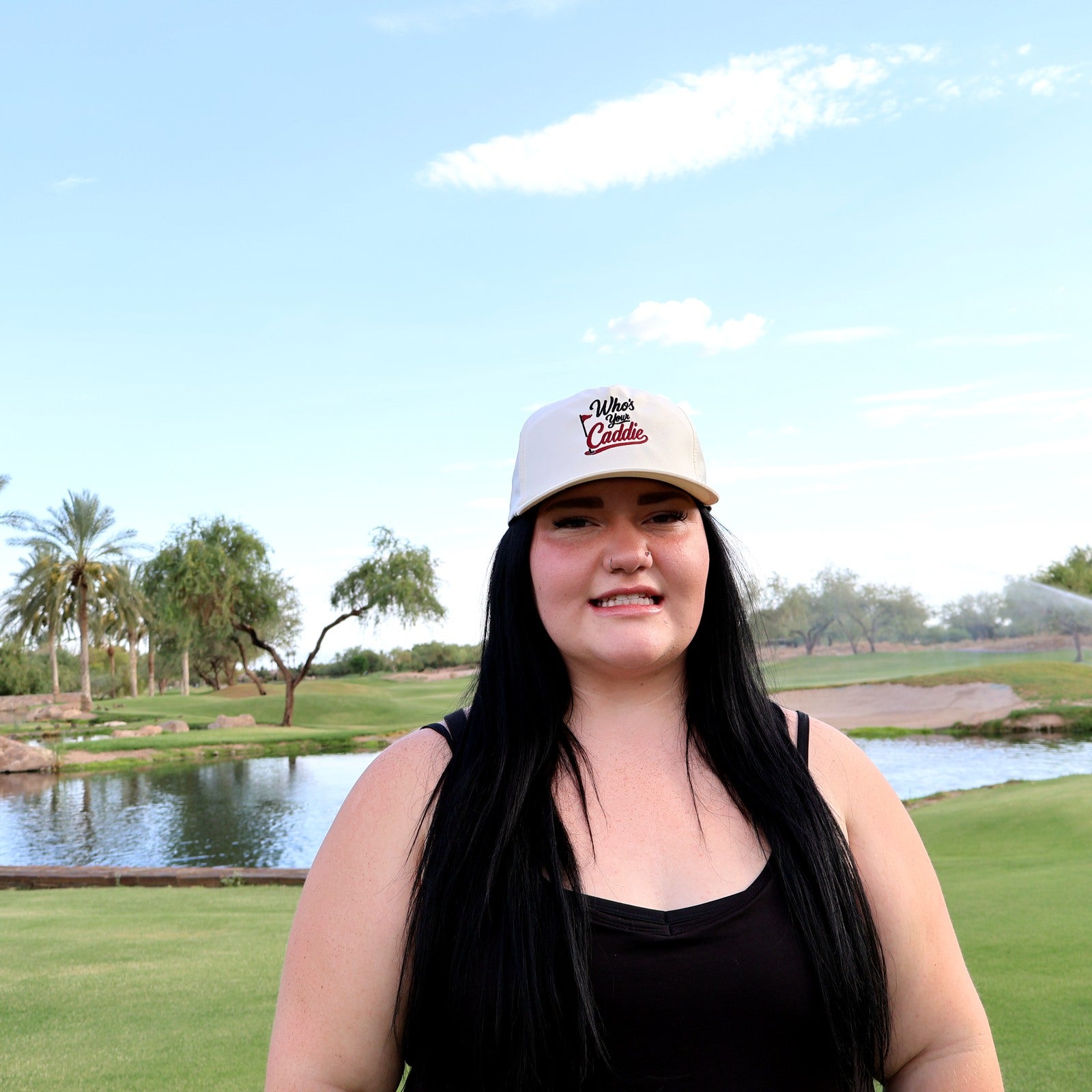 Woman wearing the ivory Who’s Your Caddie performance rope hat on the golf course