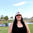 Woman wearing the ivory Who’s Your Caddie performance rope hat on the golf course